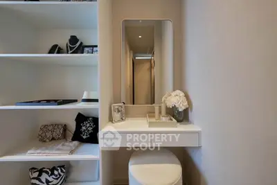 Elegant dressing area with built-in shelves and modern decor