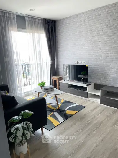 Modern living room with stylish decor, featuring a sleek TV setup and large window with city view.