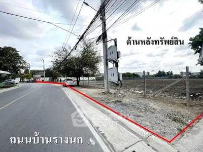 Prime land plot for sale with road access and utility connections in a developing area.