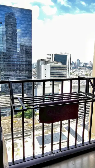 Stunning cityscape view from a high-rise balcony with modern railing, perfect for urban living.