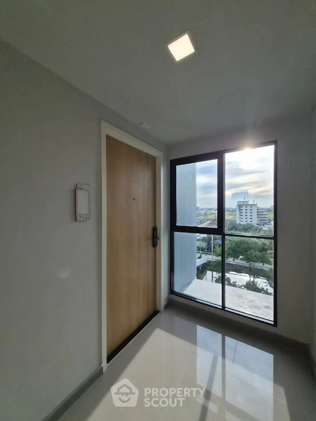 Modern apartment entrance with scenic city view from window
