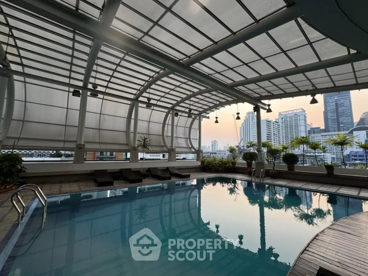 Luxurious indoor pool with stunning cityscape views and modern architecture.