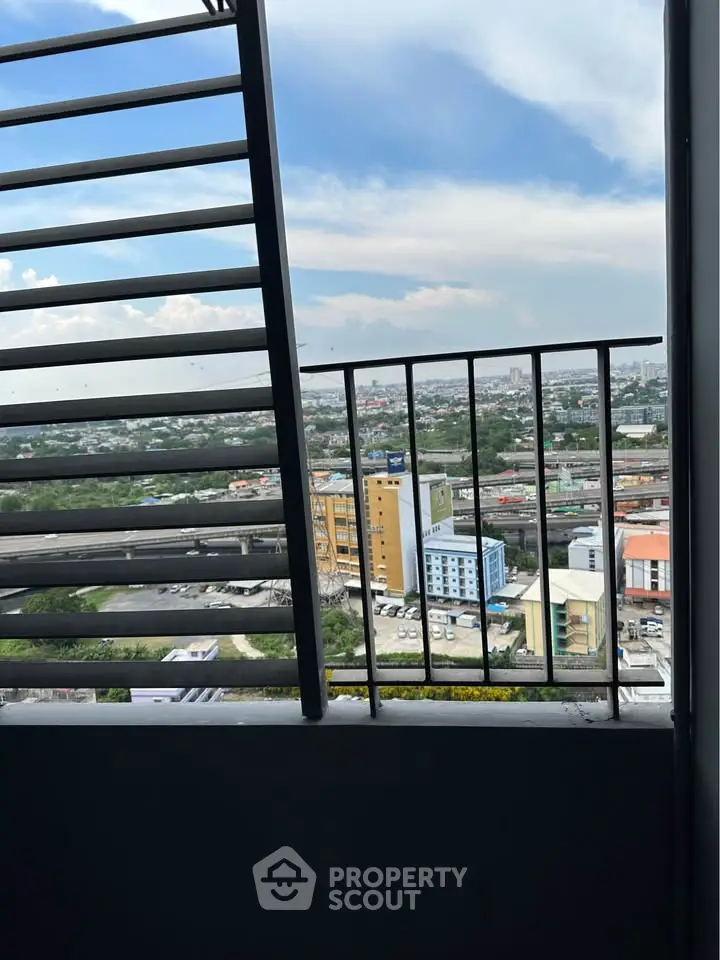 Stunning cityscape view from a high-rise balcony with modern railing design.