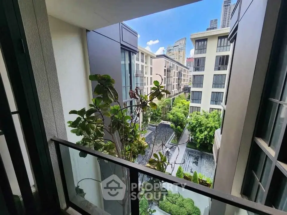 Modern urban apartment view with lush greenery and cityscape.