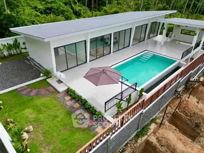 Luxurious modern villa with private pool and lush garden, perfect for serene living.