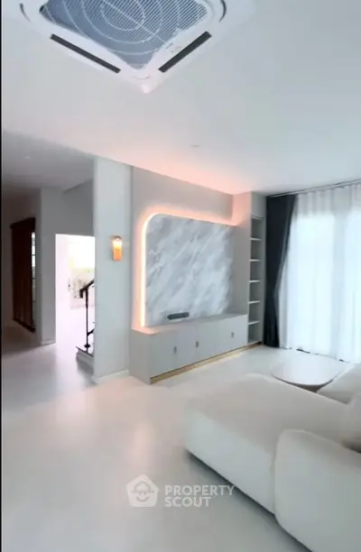 Modern living room with elegant marble accent wall and cozy sofa