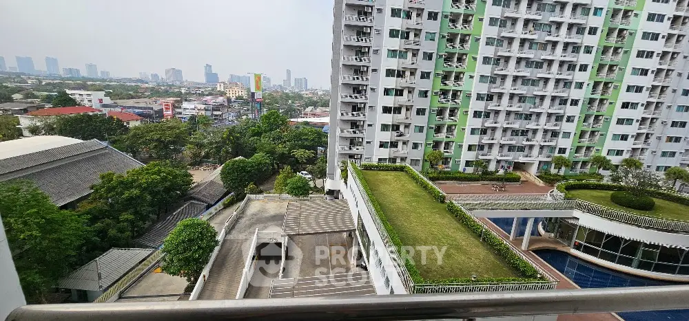 Stunning cityscape view from high-rise balcony with lush green rooftop garden