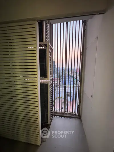 Compact balcony with city view and air conditioning units