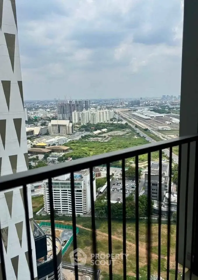 Stunning cityscape view from a high-rise balcony, showcasing urban skyline and expansive horizon.