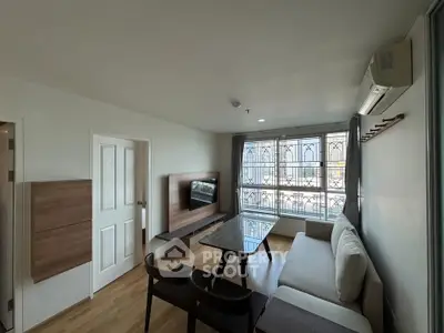 Modern living room with large window and stylish furniture