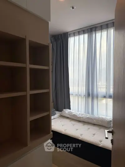 Cozy bedroom with natural light and modern shelving