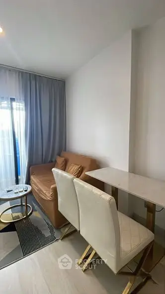 Modern living room with cozy sofa and stylish dining area in a bright apartment.