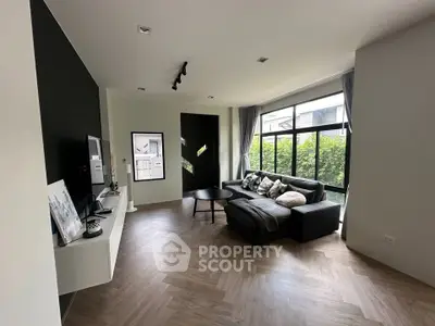 Spacious modern living room with large windows and stylish decor