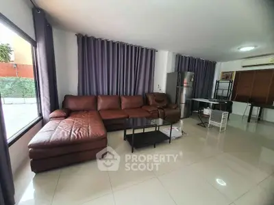 Spacious living room with leather sofa and modern decor