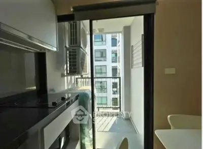 Modern kitchen with balcony view in urban apartment