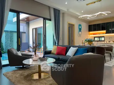 Luxurious modern living room with pool view, stylish furniture, and elegant lighting in a contemporary home.