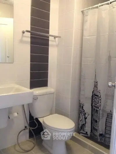 Modern bathroom with sleek design and stylish shower curtain featuring iconic landmarks.
