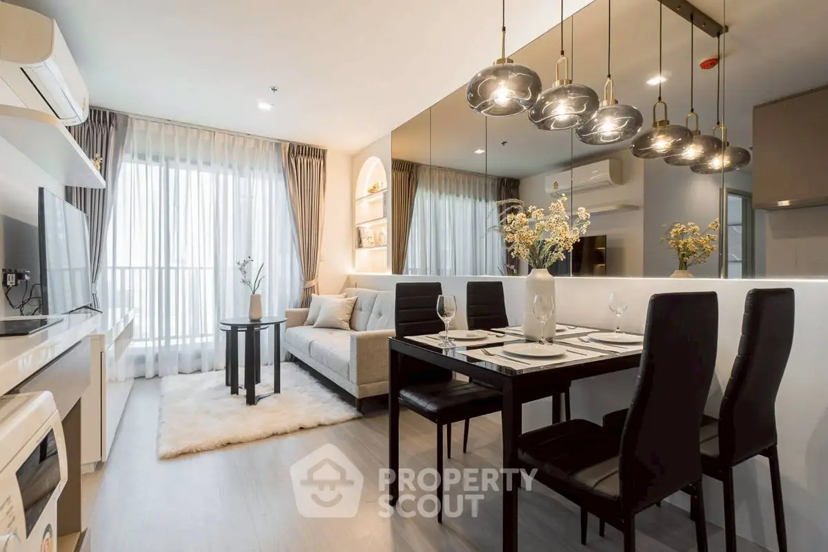 Modern living room with elegant dining area and stylish lighting in a cozy apartment.