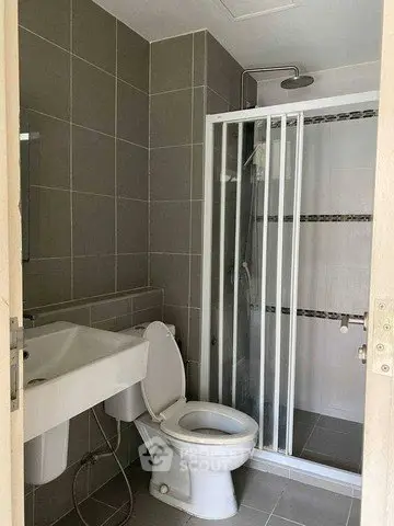 Modern bathroom with sleek shower and contemporary fixtures in a stylish apartment.