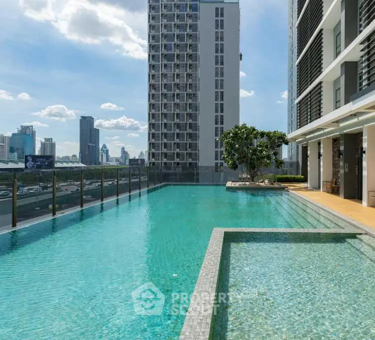 Luxurious rooftop pool with stunning city skyline views in modern high-rise building.