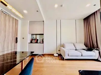Modern living room with sleek furniture and wooden flooring in a stylish apartment.