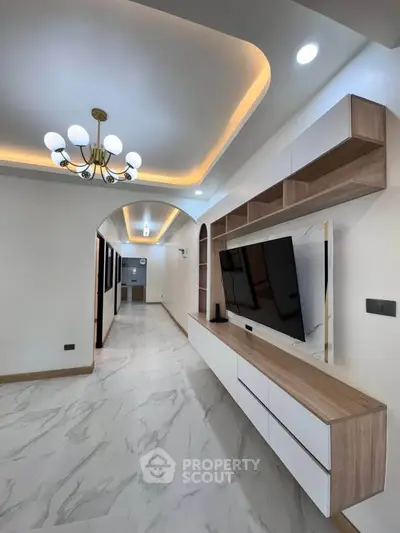 Modern living room with elegant ceiling lights and sleek TV unit