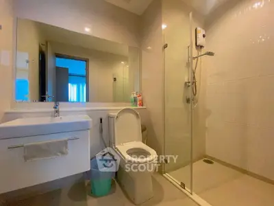 Modern bathroom with glass shower and sleek fixtures