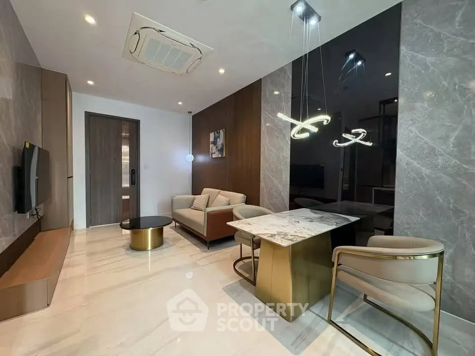 Luxurious modern living room with elegant marble accents and stylish lighting fixtures.