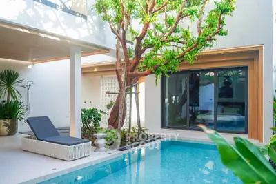 Luxurious modern home with private pool and lush greenery, perfect for relaxation and entertainment.