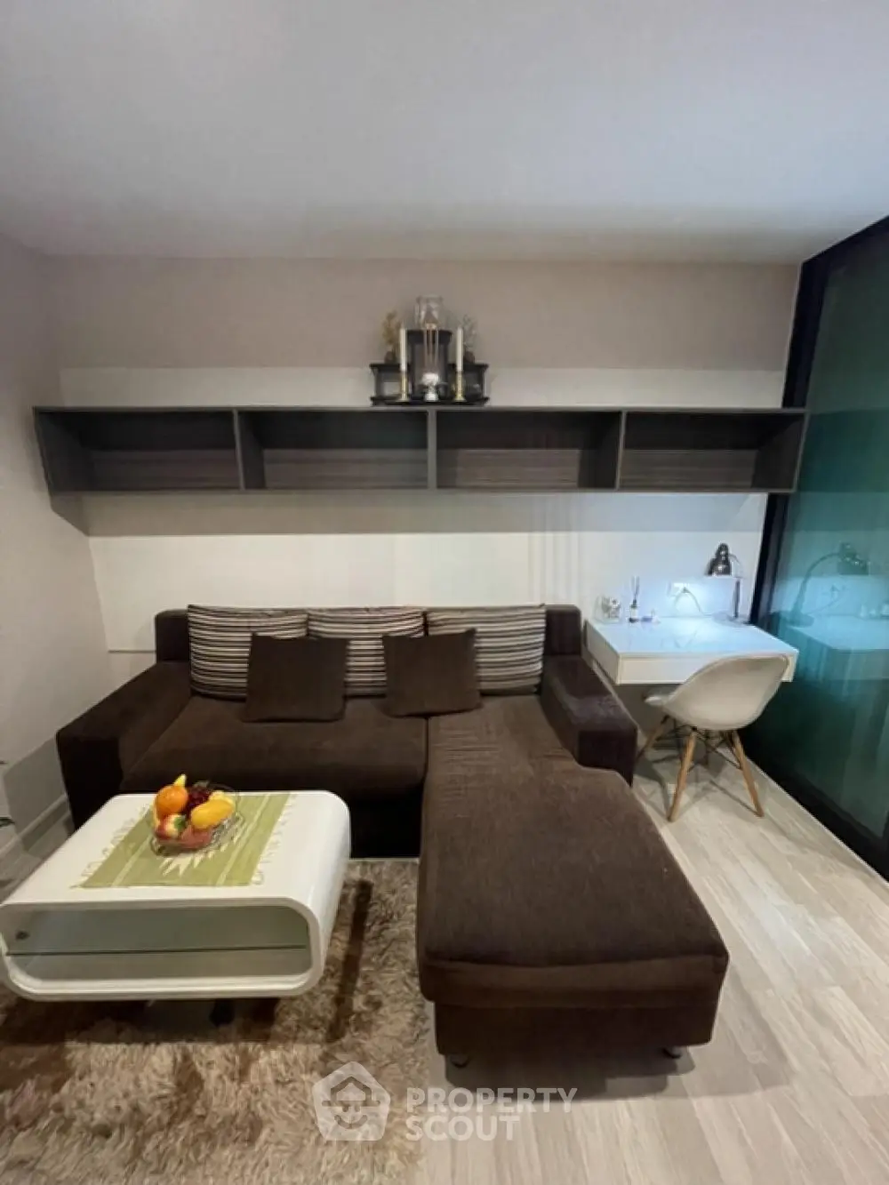 Modern living room with stylish brown sectional sofa and sleek white coffee table