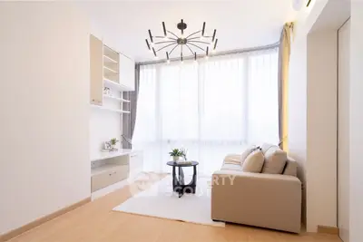 Modern living room with elegant chandelier and natural light