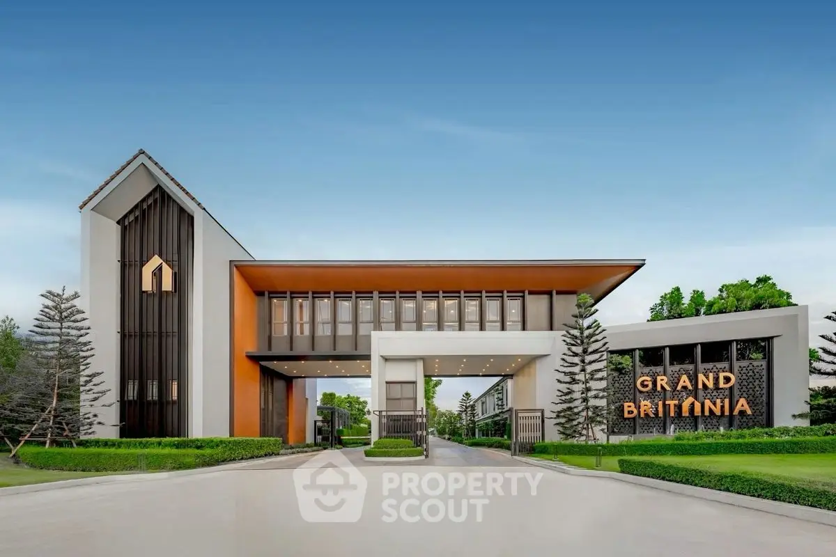 Stunning modern building entrance with sleek design and lush greenery at Grand Britania.