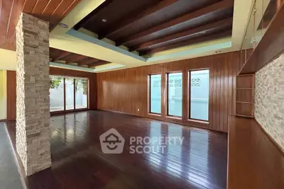 Spacious living room with wooden floors and large windows in modern home