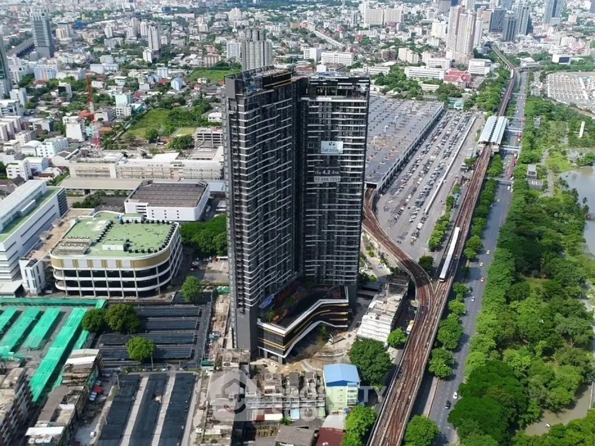 Stunning aerial view of a modern high-rise building in a bustling urban landscape.