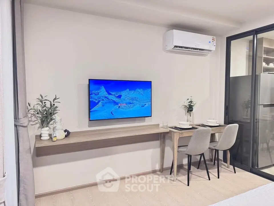 Modern living room with sleek TV setup and dining area