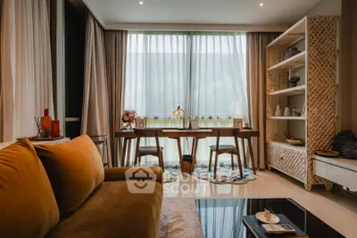 Stylish living room with modern decor and large window, perfect for relaxation and productivity.