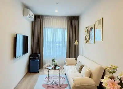 Modern living room with cozy sofa, wall art, and large window with curtains.