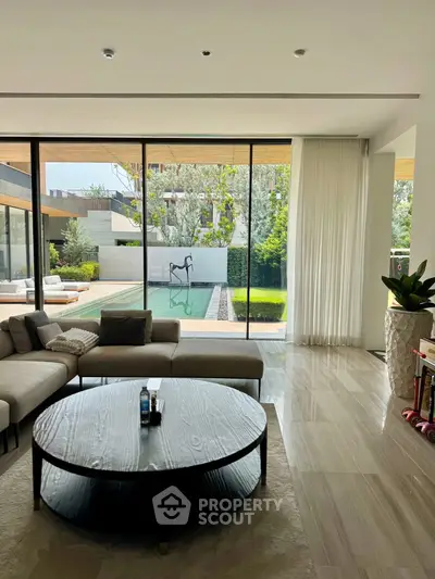 Luxurious living room with pool view and elegant decor