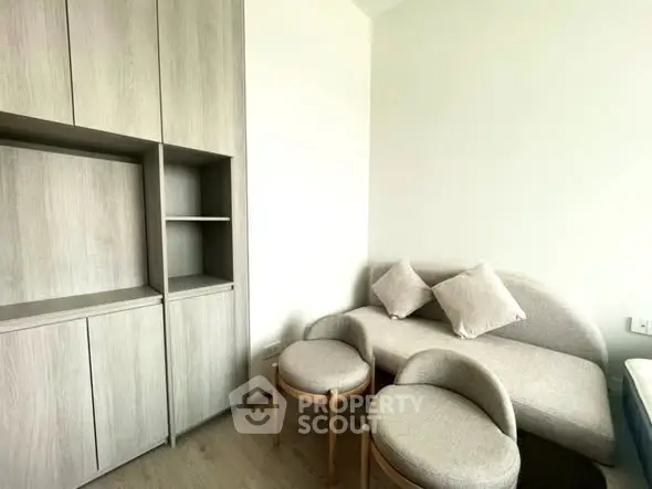 Modern living room with sleek furniture and built-in storage cabinets