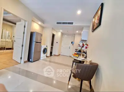 Spacious modern apartment interior with open layout, featuring sleek kitchen appliances and elegant decor.