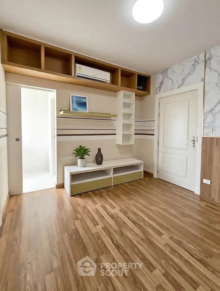 Modern living room with wooden flooring and built-in storage solutions