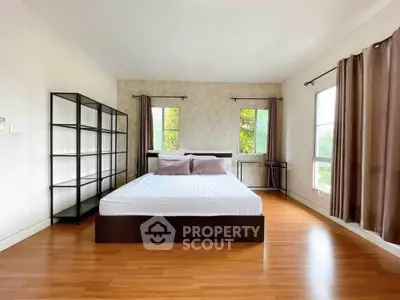 Spacious bedroom with large windows and modern decor