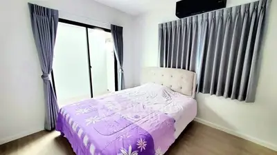 Bright bedroom with modern decor and large window for natural light