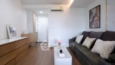 Modern living room with stylish decor and comfortable seating in a cozy apartment.