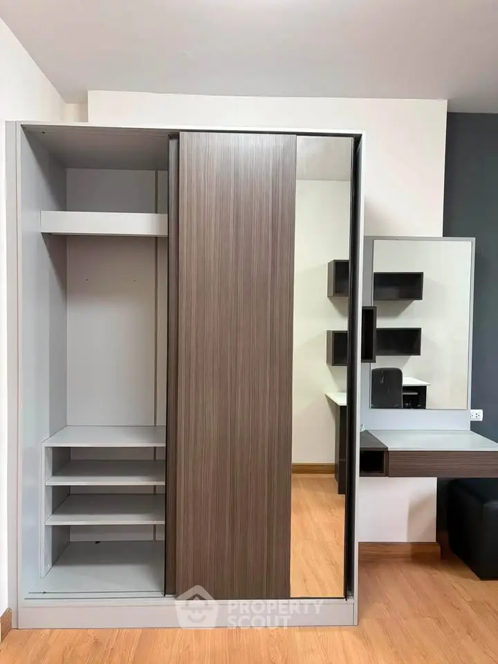 Modern bedroom with sleek wardrobe and stylish desk, perfect for contemporary living.