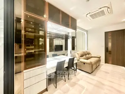 Modern living room with elegant dining area and plush seating in a stylish apartment.