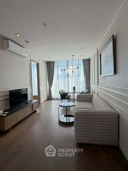 Elegant living room with modern furniture and large windows for natural light.