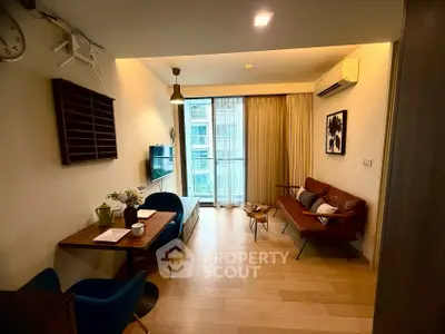 Modern living room with stylish decor and natural light in urban apartment.