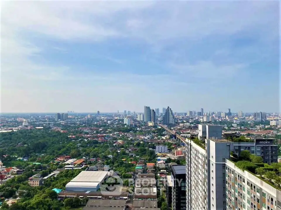 Stunning cityscape view from high-rise building with lush greenery and urban skyline.