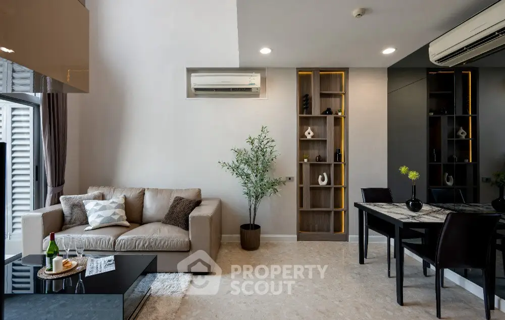 Modern living room with stylish decor, cozy sofa, and elegant dining area in a contemporary apartment.